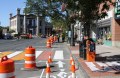 Main Street Northampton showing complete streets demonstration day in process of being set up. Shows separated bicycle lane with City Hall in background.